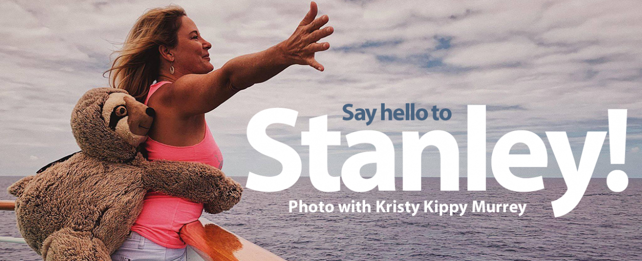 Stanley the Sloth - stuffed sloth posing with Kristy Kippy Murrey on ship over looking the ocean